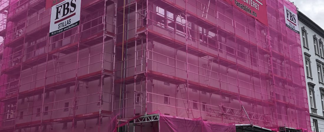 Picture showing a great building surronded by scaffold with pink net on the front. Scaffold delivered by FBS