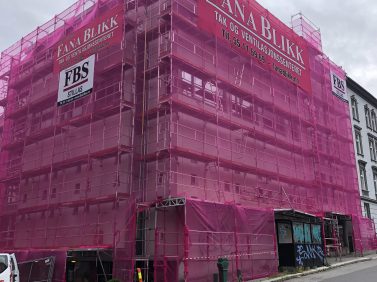 Picture showing a great building surronded by scaffold with pink net on the front. Scaffold delivered by FBS